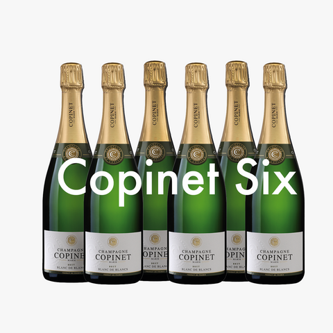 Six bottles of Copinet champagne on a white background